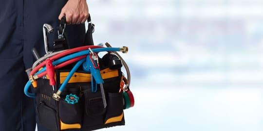 Plumber carrying a toolbox